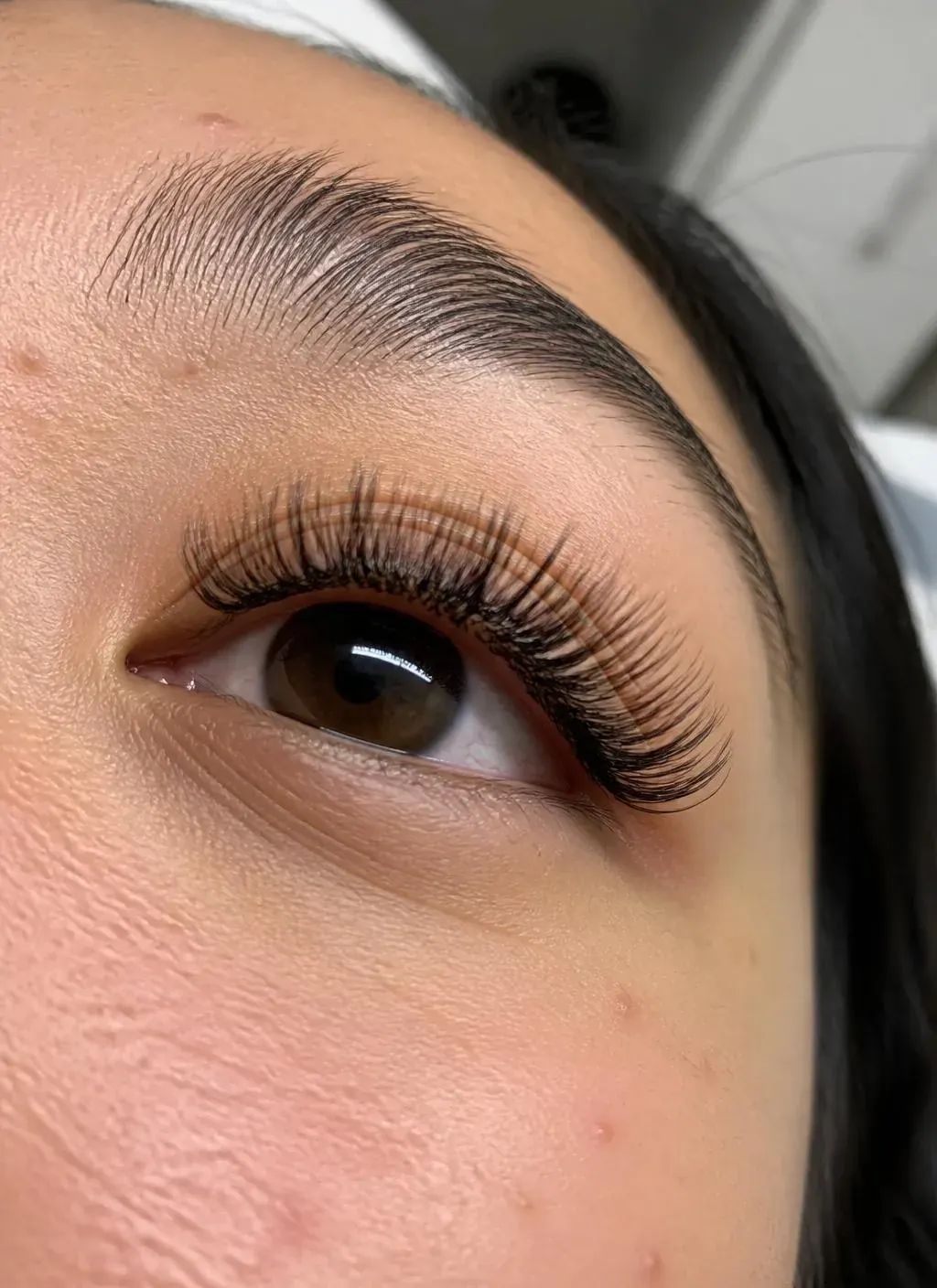 Side view of a wispy volume lash set